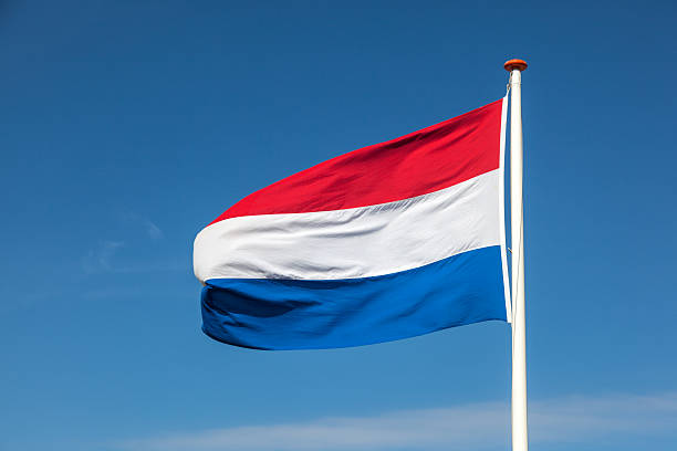 Dutch Flag Flying In A Blue Sky Stock Photo - Download Image Now