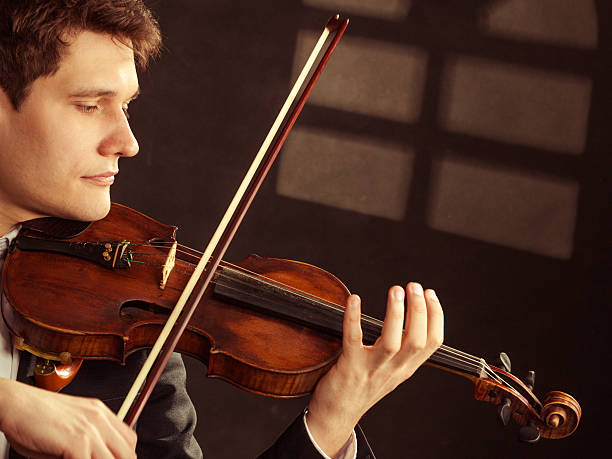 istock Man violinist playing violin. Classical music art 484896149