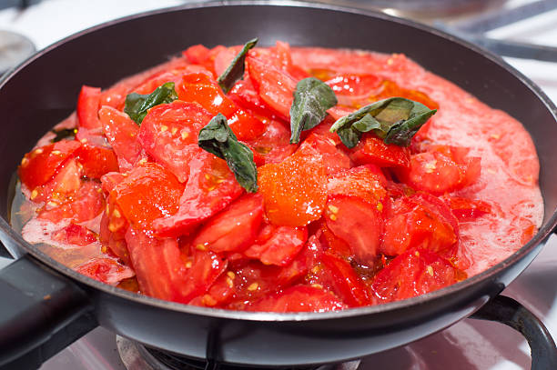 istock Fresh tomato sauce in baking, frying pan on the stove 484896408