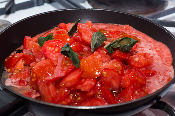 istock Fresh tomato sauce in baking, frying pan on the stove 484896410