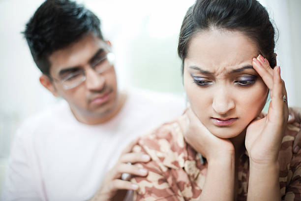istock Woman holding head with depression and headache, man consoling. 484896450
