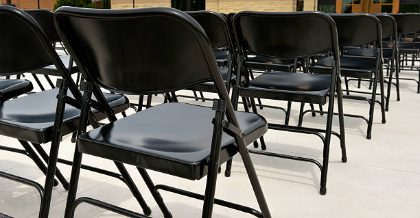 istock Rows of black folding chairs for outdoor event 484897018