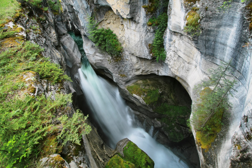 View of one of several Maligne Falls through the narrow Maligne Canyon in Jasper National Park, Alberta, Canada