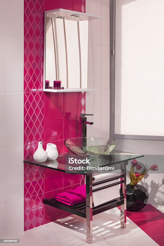 detail of a modern bathroom interior in pink and white detail of a modern bathroom interior in pink and white with sink of glass Bathroom Stock Photo