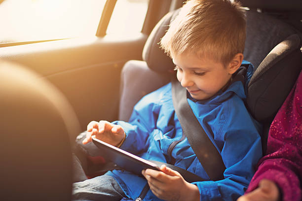 istock Little boy travelling in car with tablet 484899423