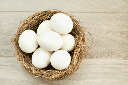 White Easter eggs in a nest, high angle view.