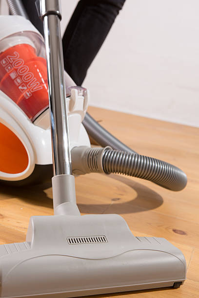 istock cleaning with vacuum cleaner in living room 484900401