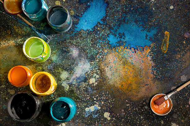 istock Cans with color paint on the floor splattered with paint that 484900426