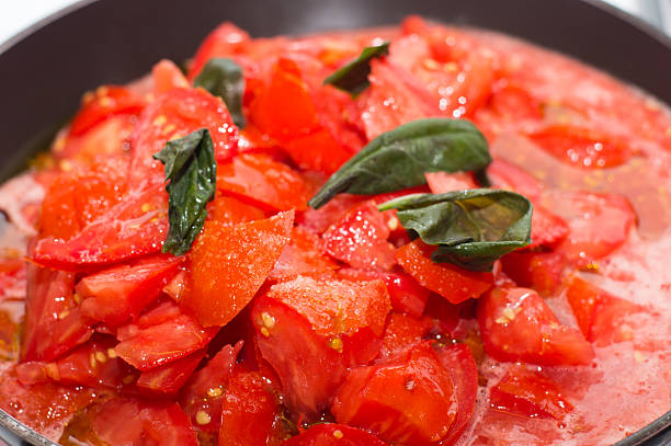 istock Fresh tomato sauce in baking, frying pan on the stove 484900966
