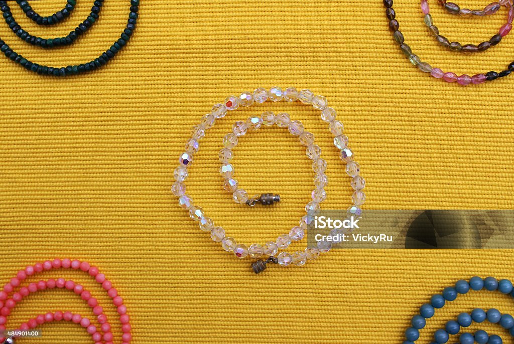 Multi colored beads Multi colored beads on a yellow background 2015 Stock Photo