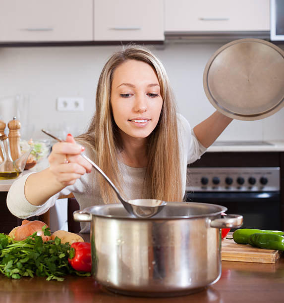 istock girl with ladle cooking soup 484901541