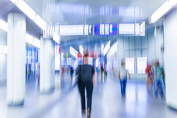 istock Motion blurred people walking in subway station. 484901710