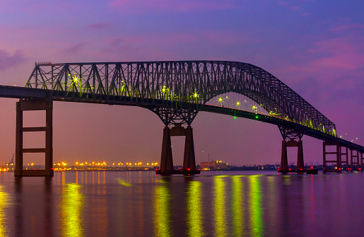 Francis Scott Key Bridge and Baltimore skyline at night with the lights on
