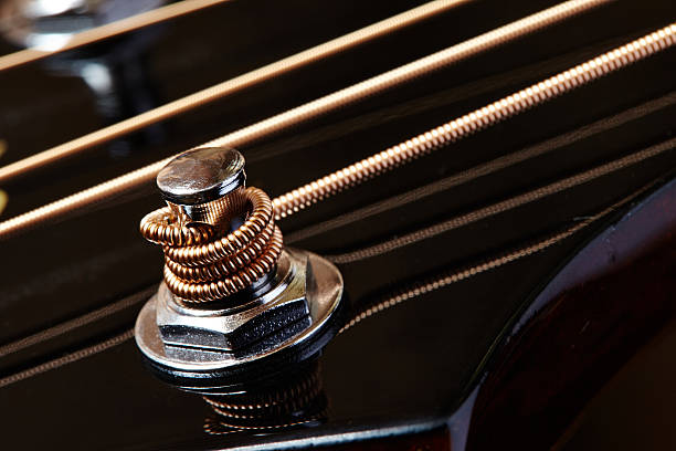 Close up detail of guitar string Close up detail of guitar string and blurred background musical instrument string stock pictures, royalty-free photos & images