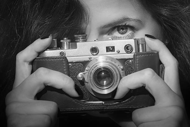 istock Young woman with retro camera. Black and white photo 484905194