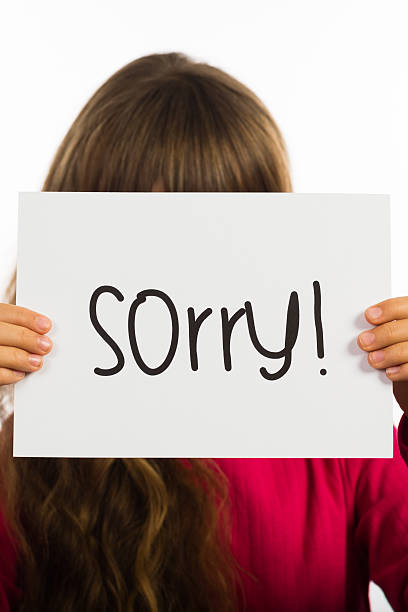 istock Child holding Sorry sign 484909424