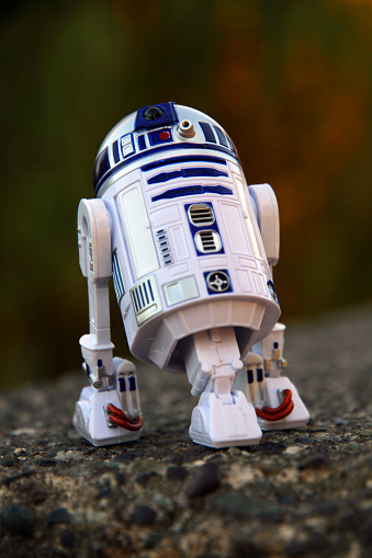 Vancouver, Canada - August 1, 2015: An R2-D2 droid from the Star Wars film franchise on a concrete platform in Vancouver. The toy is part of the Black Series, from Hasbro.
