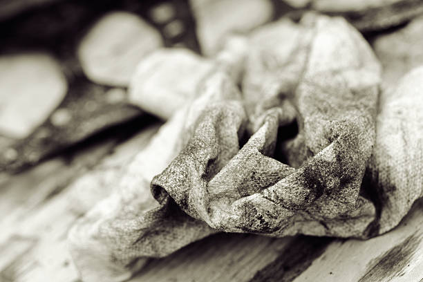 Greasy and oily rag in front of an out of focus blown cylinder head gasket.