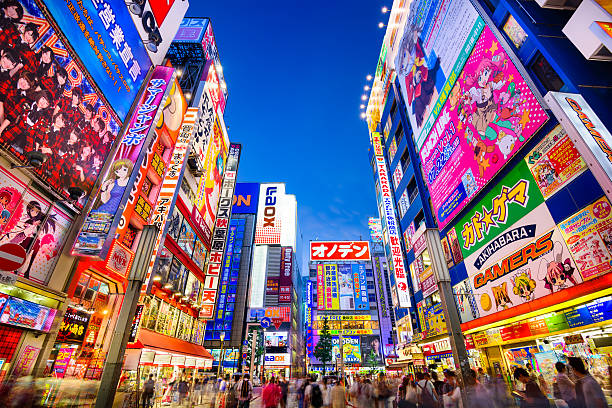 Akihabara Tokyo Tokyo, Japan - August 1, 2015: Crowds pass below colorful signs in Akihabara. The well known electronics district specializes in the sales of video games, anime, manga, and computer goods. tokyo prefecture stock pictures, royalty-free photos & images