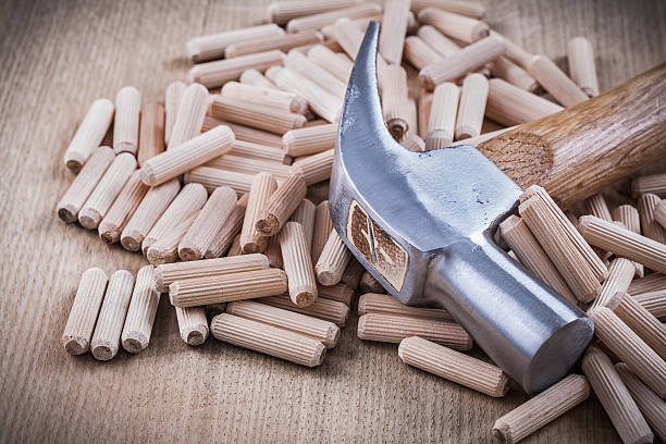 istock Wooden dowels and claw hammer top view image construction concep 484916022