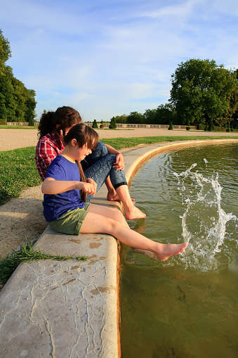 Young girls playing with the fountain