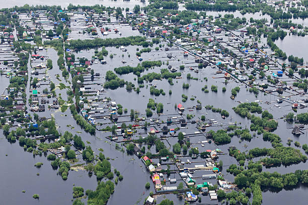 Flooded village in lowland of Great river Ob River Flood June 2015 Aerial View of same houses in vicinity of Nizhnevartovsk, Tyumen region, Russia. Aerial view of the residential area of the suburb of Nizhnevartovsk during the flood of 2015. western siberia stock pictures, royalty-free photos & images