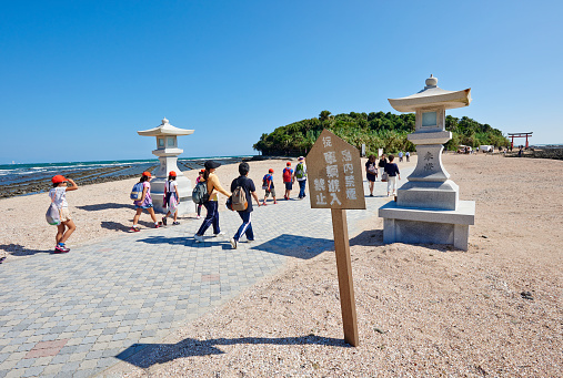 Aoshima, Japan - September 26, 2014: schoolchildren and tourists entering at Aoshima Island. The island is a popular tourist destination in Miyazaki Prefecture.