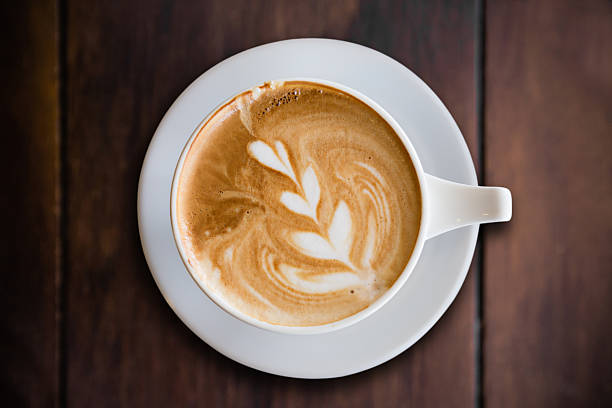 istock hot cappuccino with latte art on wood background 484930516