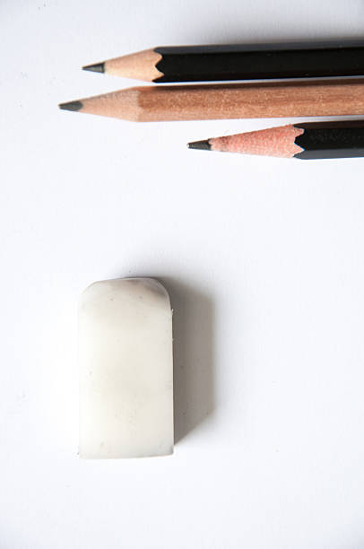 istock three pencil and one eraser on white background 484932600