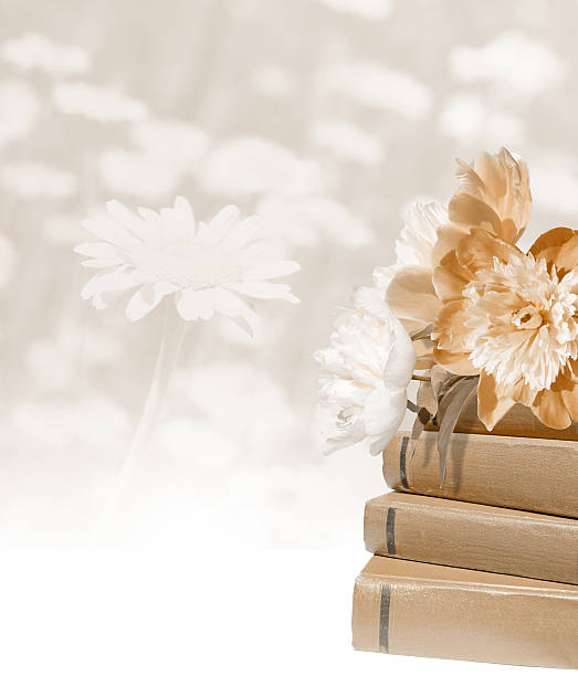 Flowers on a pile of books. Lighn beige postcard. Education collage. Teacher's day