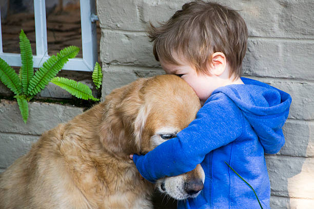 istock Little Boy Hugging His Dog - Golden Retriever 484937922
