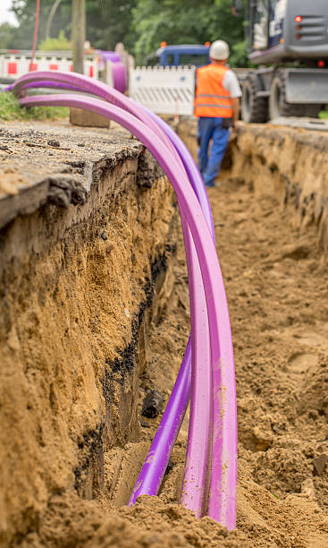 Fiberglass network under construction with pipes for laying optical fiber Fiberglass network under construction with pipes for laying optical fiber digital subscriber line stock pictures, royalty-free photos & images