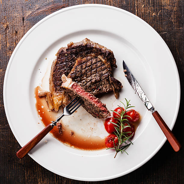 istock Sliced grilled Beef steak Ribeye with cherry tomatoes 484938902