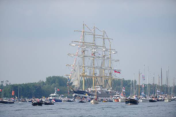 Amsterdam, The Netherlands - August 19, 2015: Parade of Tall Ships during Sail Amsterdam, the largest public event in the Netherlands. With spectators in small sailing boats.