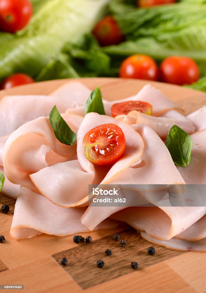 sliced turkey breast appetizer of sliced turkey breast rolled up on the cutting board 2015 Stock Photo