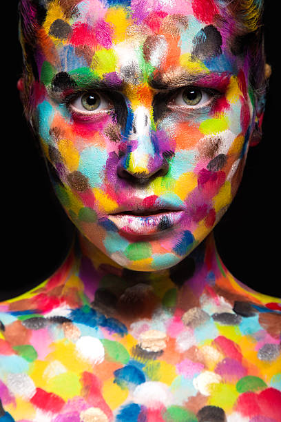 istock Girl with colored face painted. Art beauty image 484942610