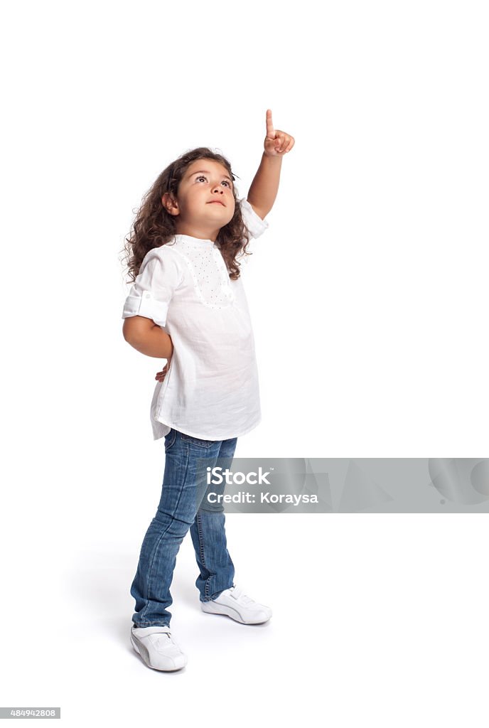 Full length portrait of a happy little girl on white Full length portrait of a happy little girl on white background pointing Child Stock Photo