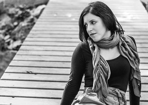 istock black and white copy-space boardwalk looking girl 484942960