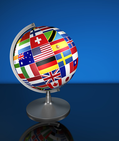 Travel, services, marketing and international business management concept with a school globe and international flags of the world, illustration on blue background.