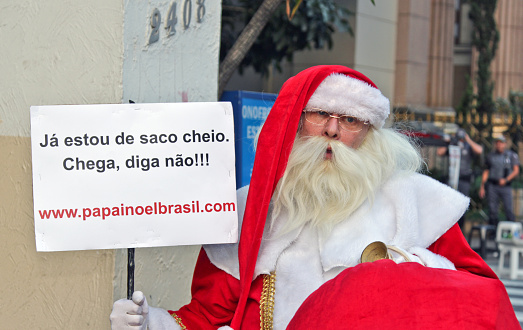 Sao Paulo, Brazil - August 16, 2015: An unidentified man with the Santa Clau costume in the protest against federal government corruption in Sao Paulo Brazil.
