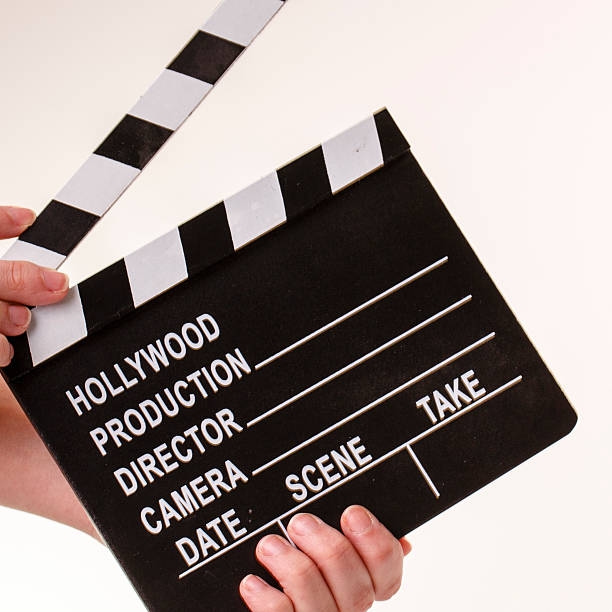 istock Movie flapper in woman´s hands on white background 484946041