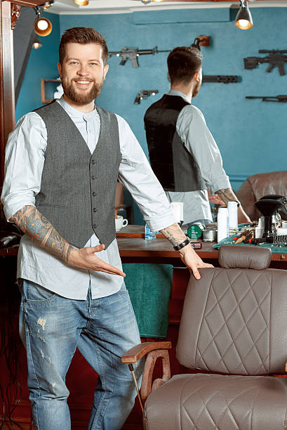 istock Happy barber leaning on a chair 484949004