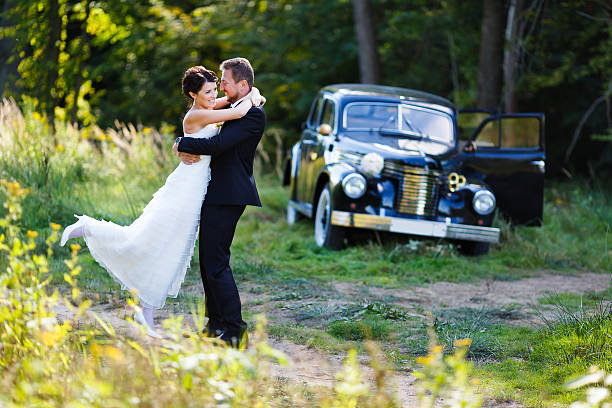 istock Wedding couple with old car 484949652