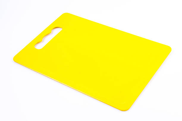 istock Yellow plastic cutting board on isolated white background 484950111