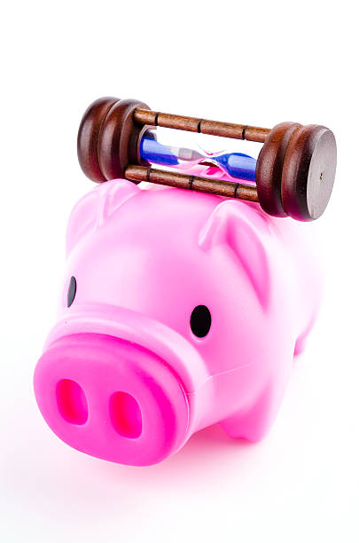 istock piggy bank sand clock isolated white background 484950117