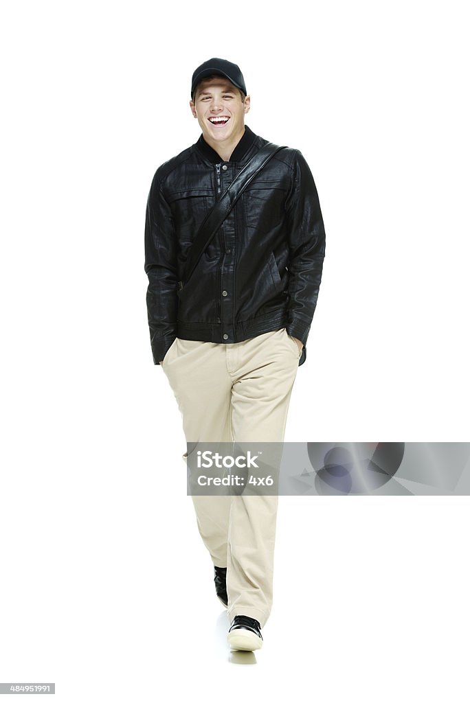 Cheerful man walking with hands in pocket Cheerful man walking with hands in pockethttp://www.twodozendesign.info/i/1.png 20-29 Years Stock Photo