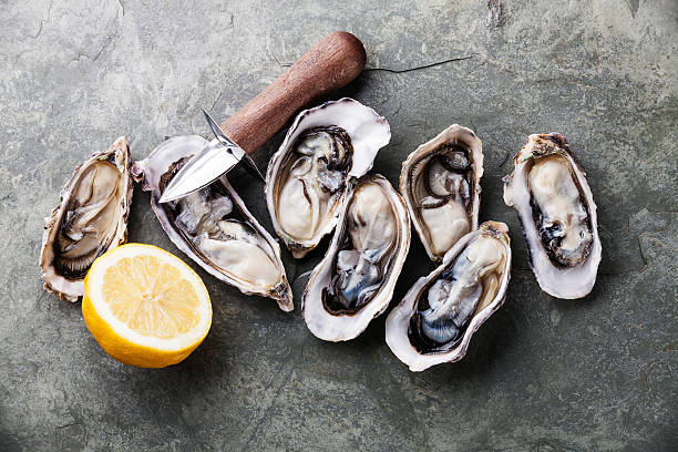 istock Opened Oysters with lemon and oyster knife 484957080