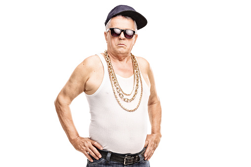 Senior man in hip-hop clothes looking at the camera isolated on white background