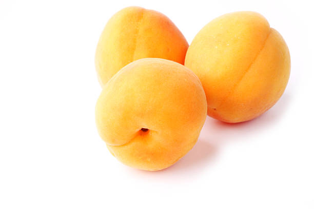 istock Three apricots isolated on a white background farm organic product 484960994