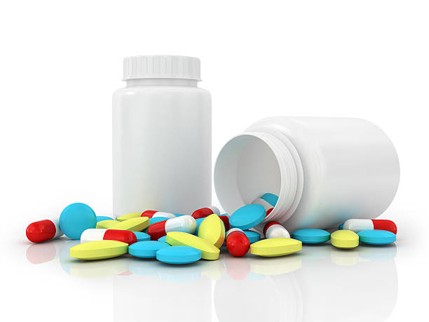 istock White jar with an open cover and pink tablets 484963394